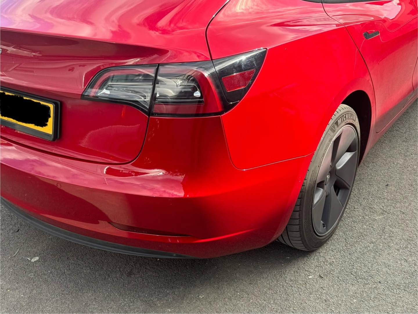 Clean red Tesla rear bodywork after repair by PBS Autos