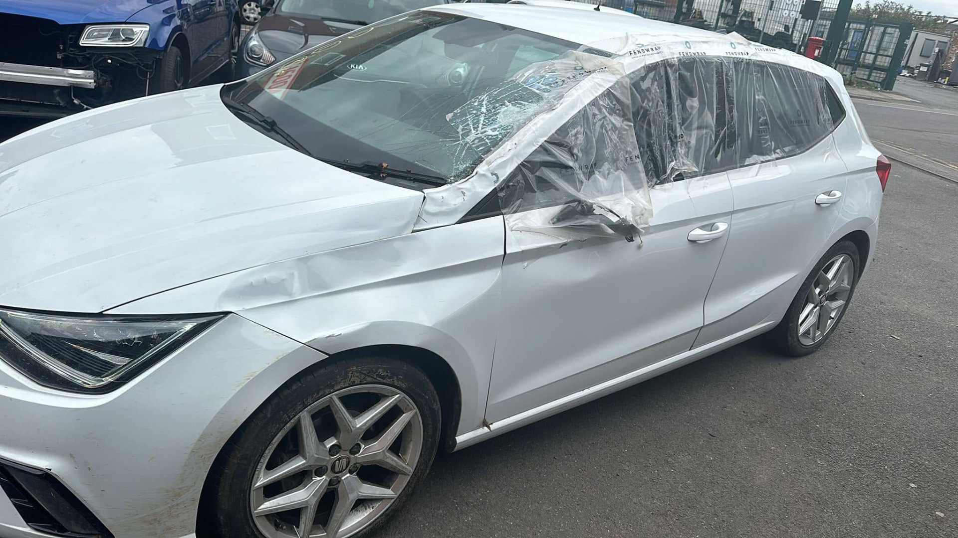 The same white SEAT with accident-damaged panels and roof before repair